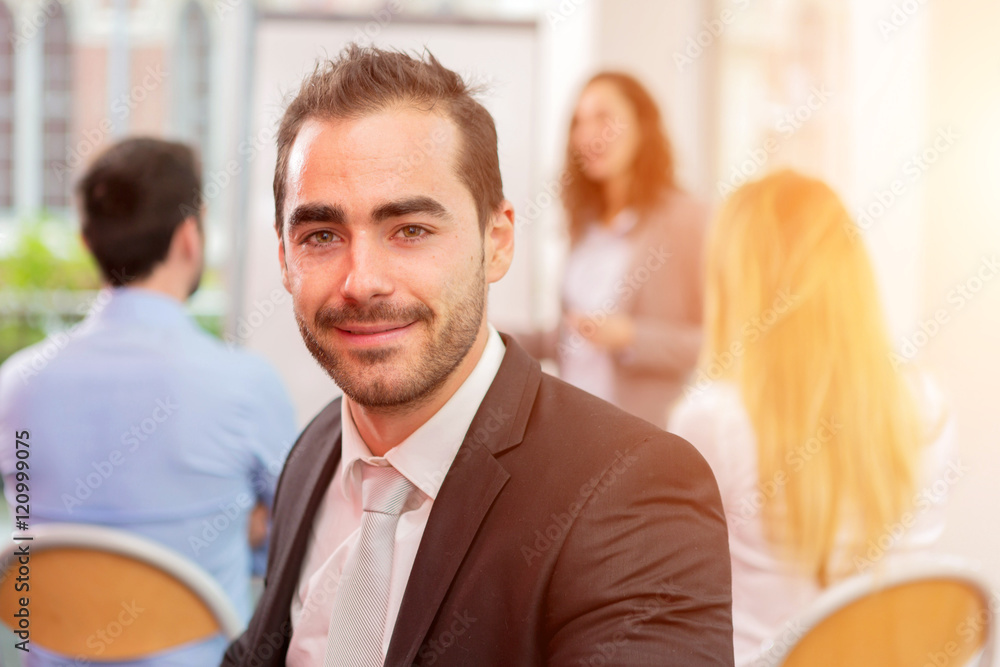 Young attractive businessman working at the office with associat Young attractive businessman working at the office with associat
