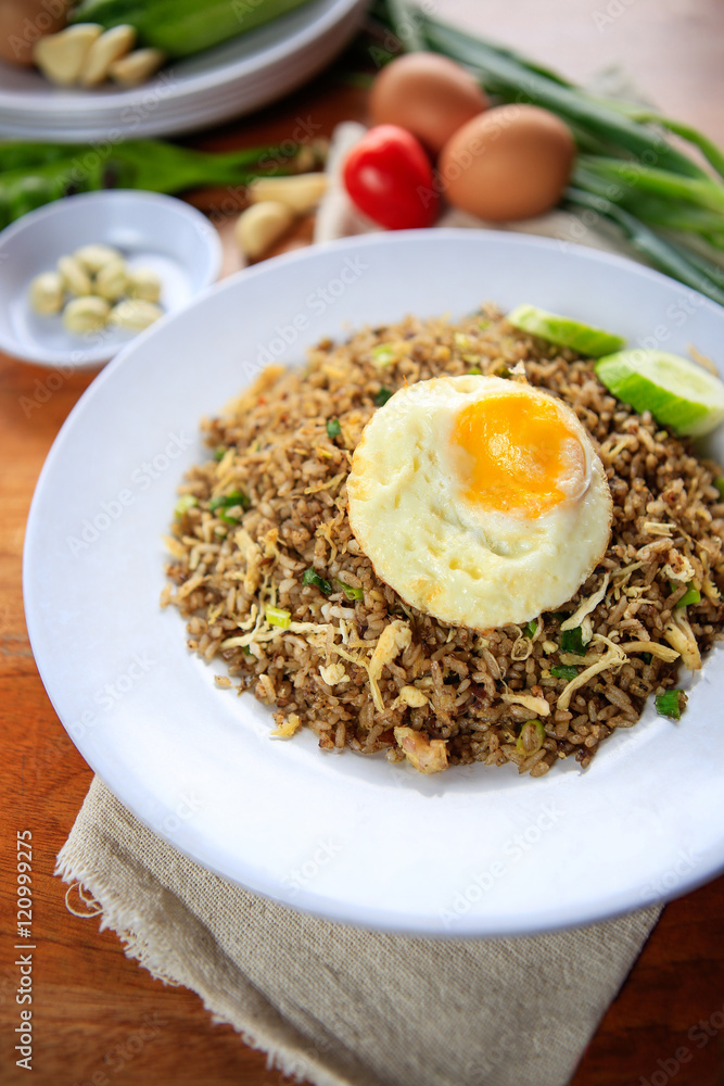 Indonesia Nasi Goreng fried rice with egg on white plate Indonesia Nasi Goreng fried rice with egg on white plate