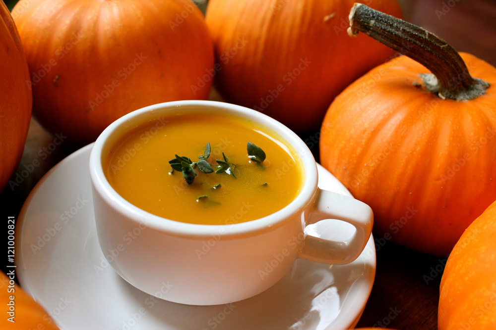 Pumpkin soup with potatoes and chestnuts in white cup Pumpkin soup with potatoes and chestnuts in white cup