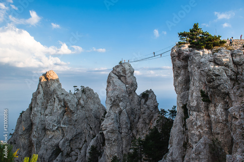 Rocks teeth above Yalta - celebrity Russia occupied Crimea. Ukrainians on the top of the cliff and cross Ukrainian climbers pulled the bridge for the development  extreme tourism. photo