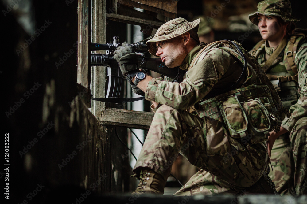 Fototapeta premium Soldiers on patrol in destroyed city. Military and rescue operation
