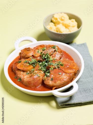 Osso buco con gremolata or Veal Shank Milanese on white plate in
