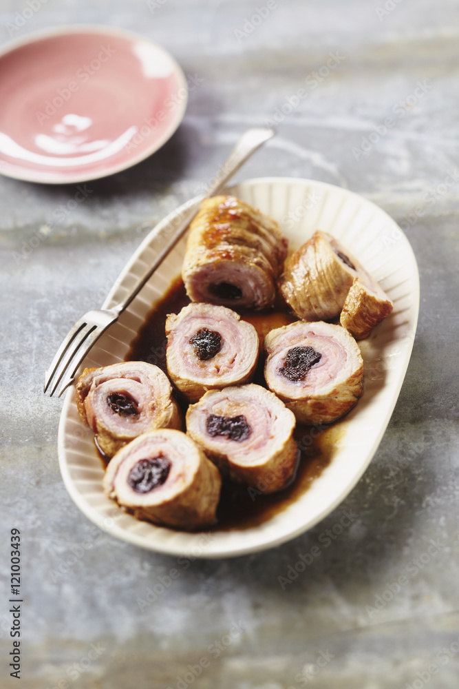 Veal rolled with bacon and prunes in plate in restaurant Veal rolled with bacon and prunes in plate in restaurant