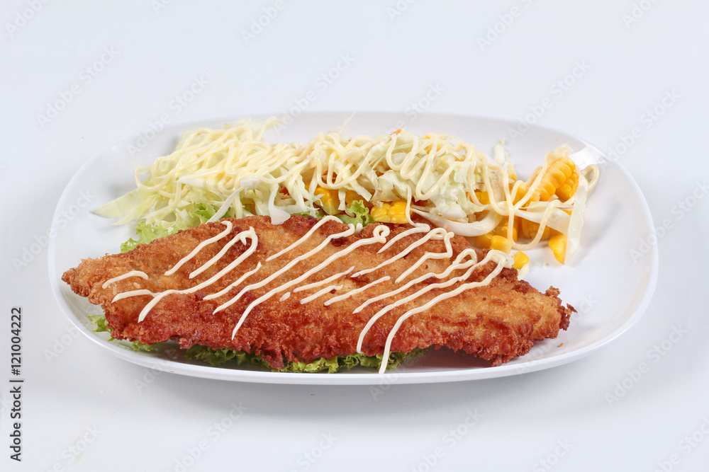 Dolly's Fish Fry with mixed vegetable salad on white background. Side view. Dolly's Fish Fry with mixed vegetable salad on white background. Side view.