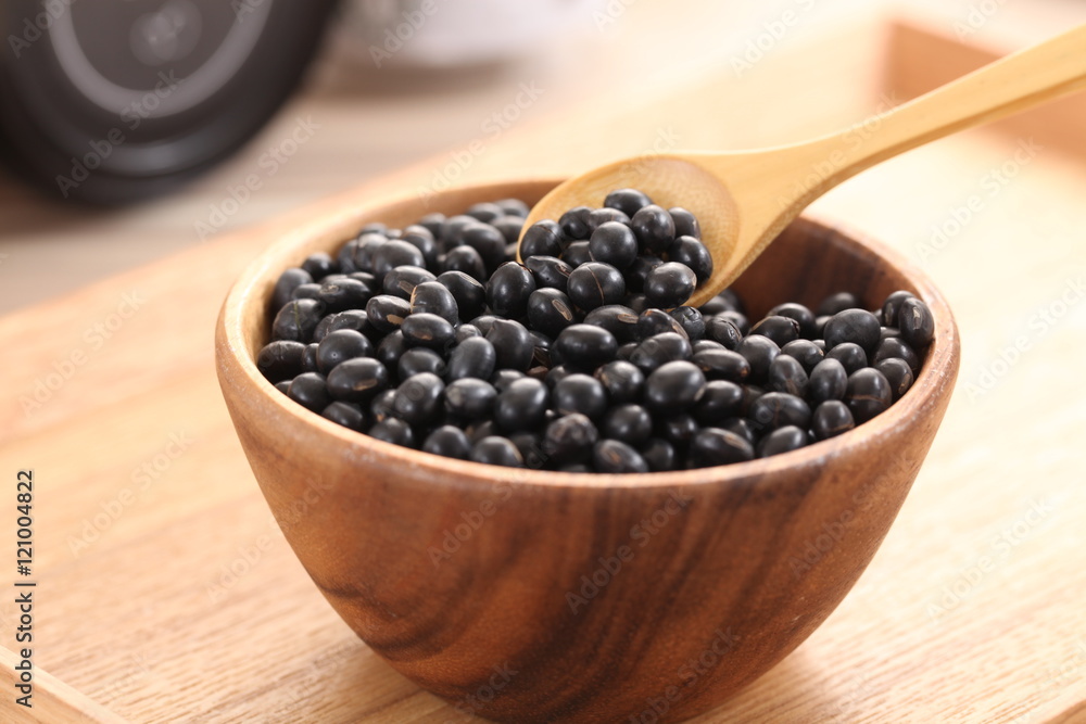 Black beans in wooden bowl on the table Black beans in wooden bowl on the table