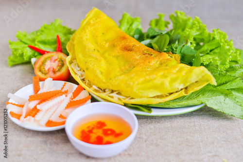 Vietnamese rice pancake with fish sauce, tomato and fermented ca