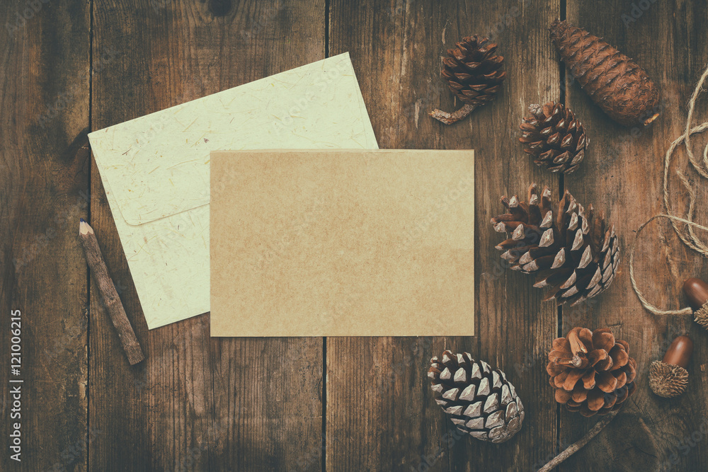 Top view of pine cones and blank card. Retro filtered Top view of pine cones and blank card. Retro filtered