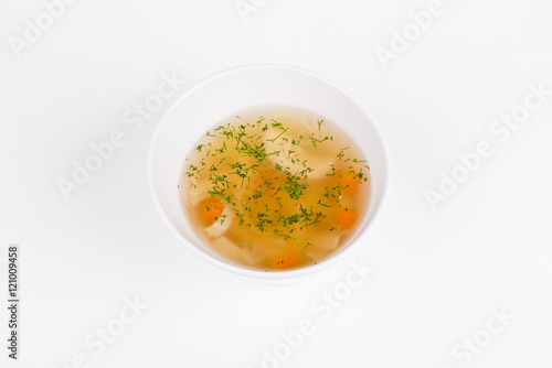 Chicken soup with home-made pasta in white bowl background