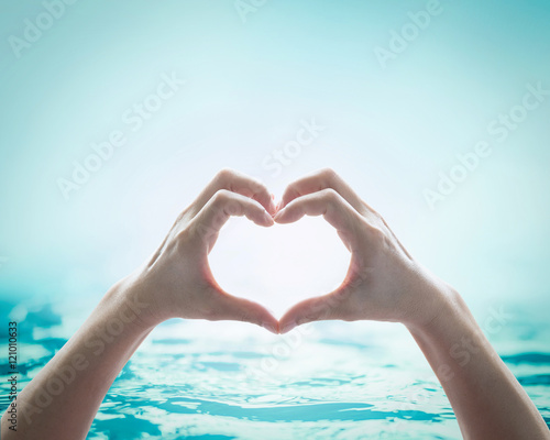 Collaborative female human hands on blurred wavy clean water background  Saving water clean natural environment ocean concept  campaign  Love earth  save water conceptual idea  sign