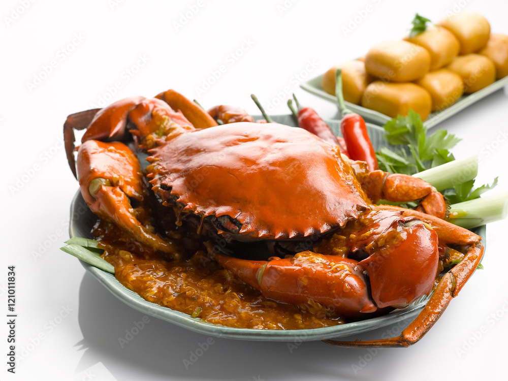 Special fried crab with chili sauce and fried dumplings on white Special fried crab with chili sauce and fried dumplings on white