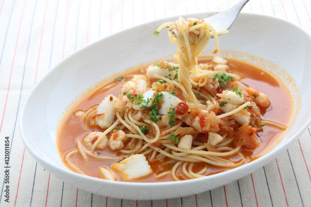 Pasta noodle with seafood, scallop and squids in white bowl on w