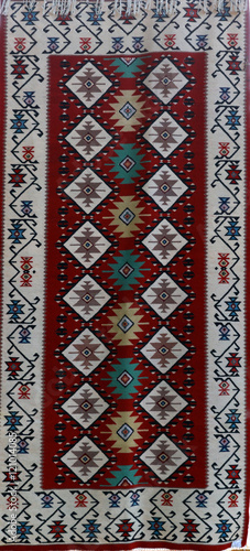 Hand-woven carpet with ethnic and folk pattern photo