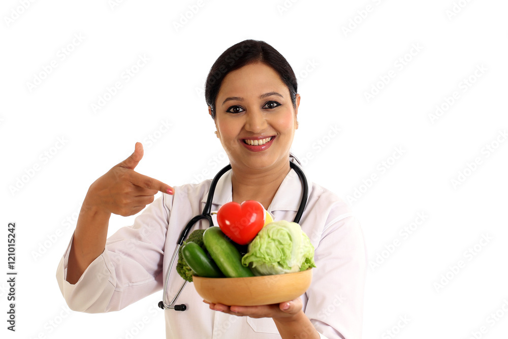 Young female nutritionist doctor holding bowl of vegetables Young female nutritionist doctor holding bowl of vegetables