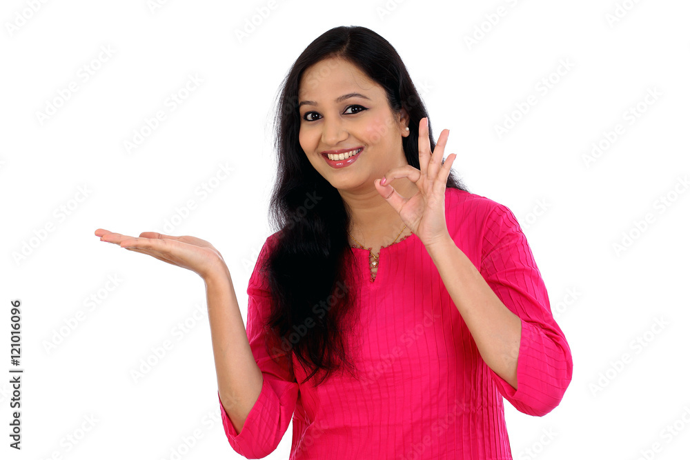 Surprised young woman pointing at a product Surprised young woman pointing at a product