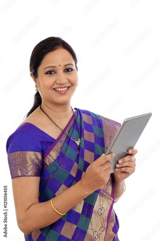 Traditional Indian woman using a tablet computer Traditional Indian woman using a tablet computer