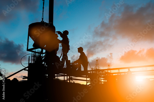 Wall Mural Silhouette People Heavy Construction workers working on scaffold