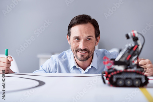 Joyful man making technical achievement photo