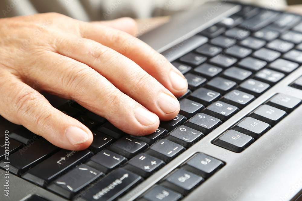 Hand of old senior on a computer keyboard Hand of old senior on a computer keyboard