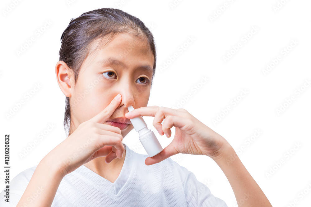 Teenage girl using nasal spray, white background Teenage girl using nasal spray, white background