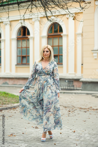 blonde woman walking in the park