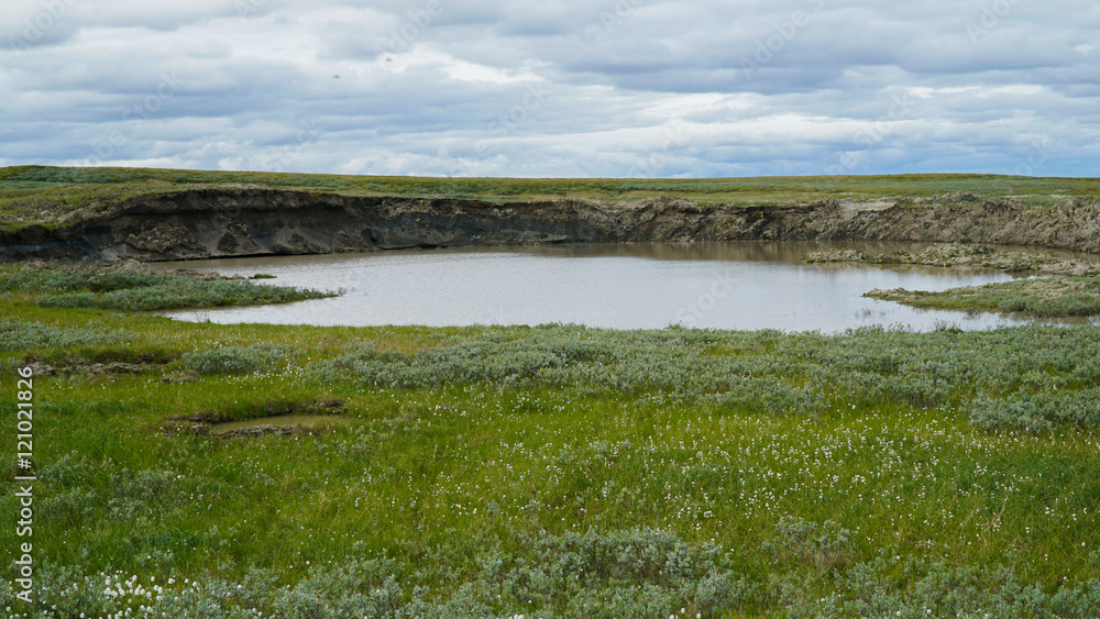 YAMAL PENINSULA, RUSSIA - JUNE 18, 2015: Expedition to the giant funnel of unknown origin. Former crater, which became a lake. YAMAL PENINSULA, RUSSIA - JUNE 18, 2015: Expedition to the giant funnel of unknown origin. Former crater, which became a lake.