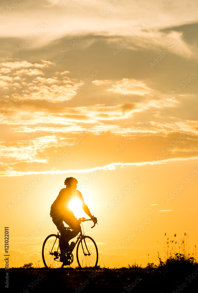 Silhouette of cyclist motion on sunset background Silhouette of cyclist motion on sunset background