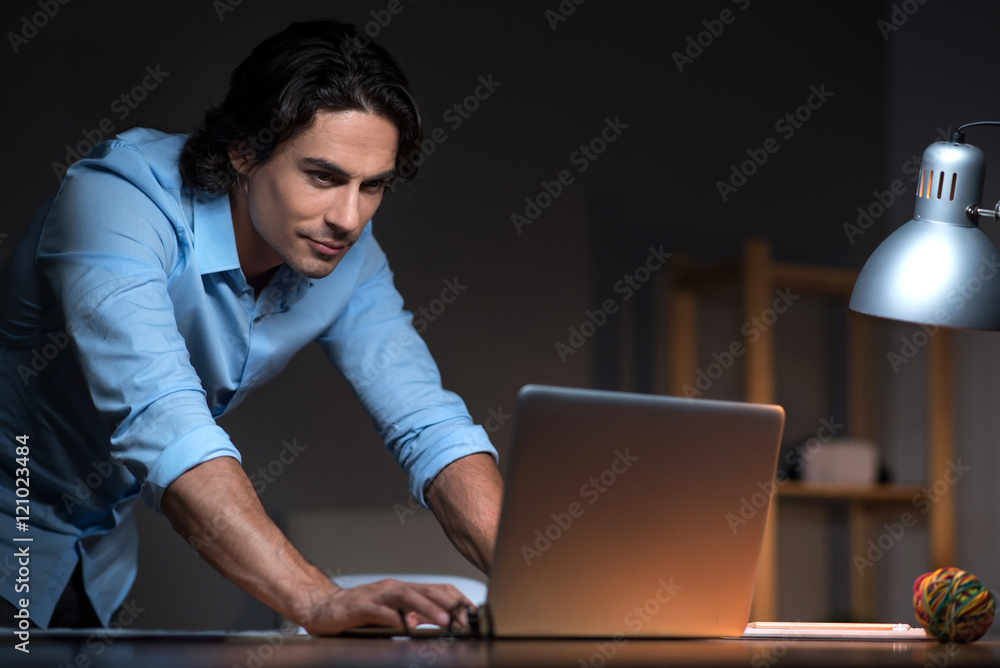 Delighted man standing with laptop Delighted man standing with laptop