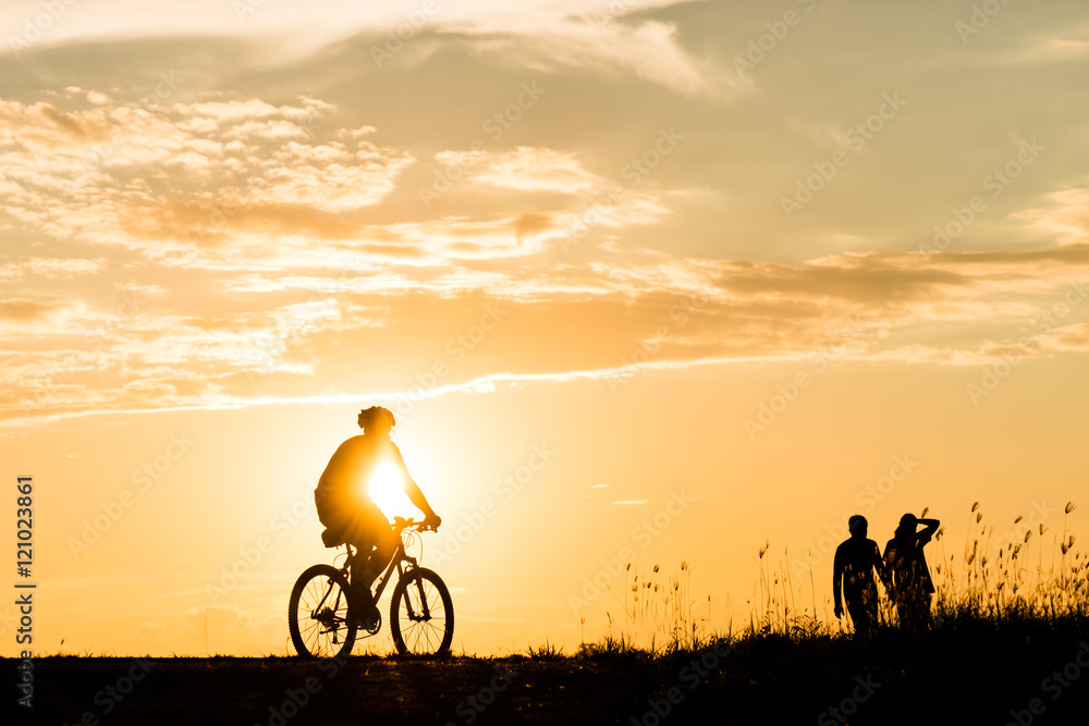 Silhouette of cyclist motion on sunset background