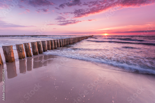 Wooden breakwater - Baltic seascape at sunset, Poland © tomeyk