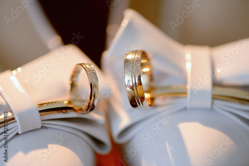 Beautiful wedding rings for bride and groom. Beauty of wedding accessories indoors. Close-up bridal jewel of marriage. Female and male decoration for couple. Jewelry for man and woman