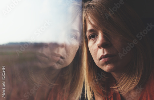 A woman in train alone and sad