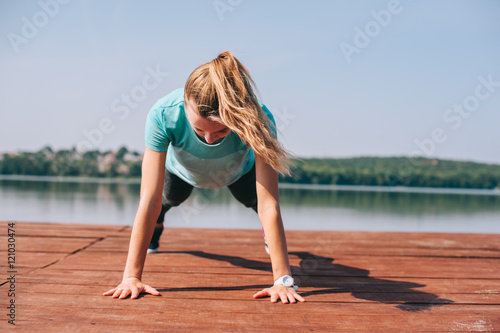 She performs exercises on pier