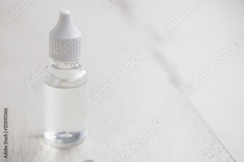 E-cig vaping glycerin liquid in transparent bottle photo