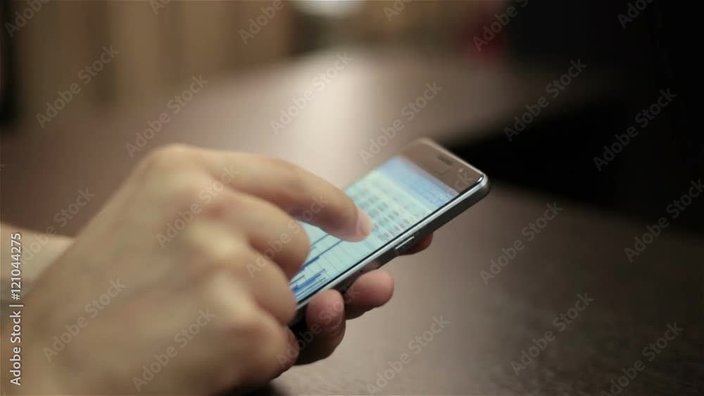 businessman looks at financial data on mobile businessman looks at financial data on mobile