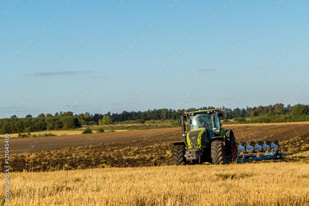 Agriculture plowing tractor on wheat cereal fields Agriculture plowing tractor on wheat cereal fields