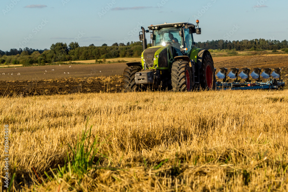 Agriculture plowing tractor on wheat cereal fields Agriculture plowing tractor on wheat cereal fields