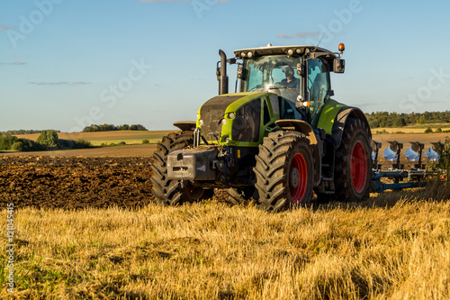 Agriculture plowing tractor on wheat cereal fields