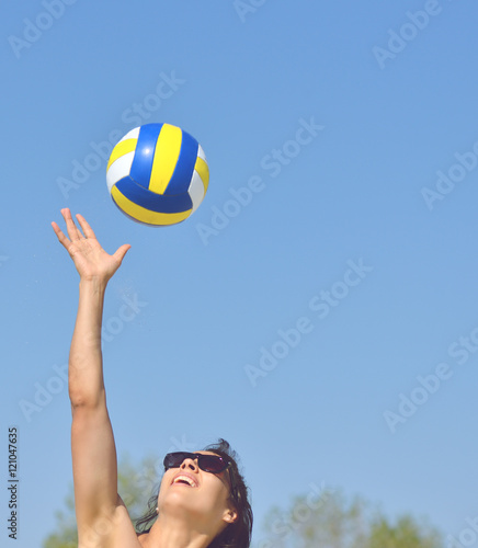Young girl playing volleyball in the beach © tutye
