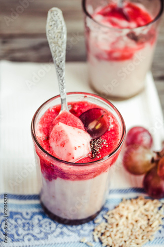 oatmeal pudding with strawberry sauce and grapes, close-up,tinti