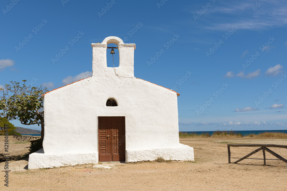 Church of Saint Lucia, Posada. / North Sardinia. Small church with a single nave, the white facade with the entry portal which is surmounted by a large belfry. Church of Saint Lucia, Posada. / North Sardinia. Small church with a single nave, the white facade with the entry portal which is surmounted by a large belfry.