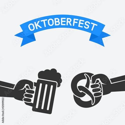 Oktoberfest concept. Hand with beer mug and pretzel