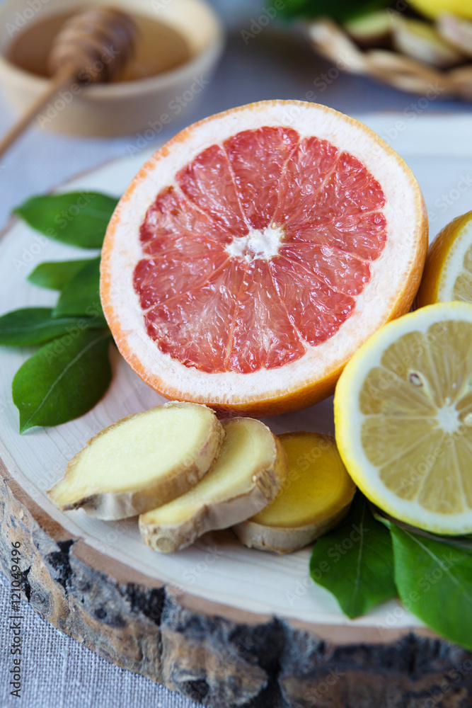 Close up of grapefruit and lemons with honey Close up of grapefruit and lemons with honey