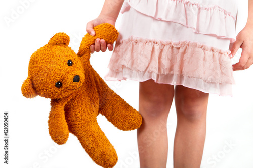 little girl with her teddy bear friend in hand