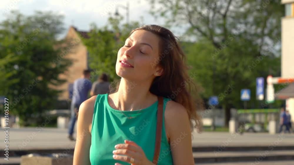 Happy girl sitting in town and playing with her hair, slow motion shot at 240fps
Happy girl sitting in town and playing with her hair, slow motion shot at 240fps