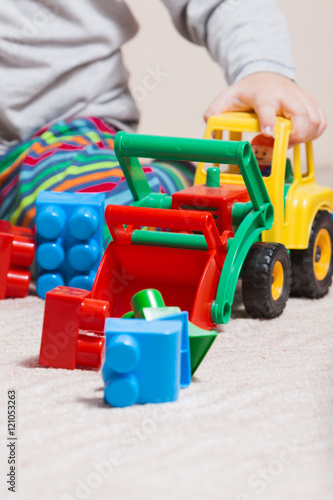 Playing little boy with colored cubes