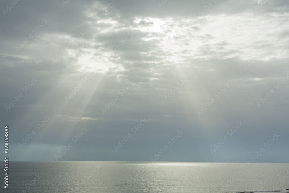 Ray of sun through the clouds lighting the horizon line between Ray of sun through the clouds lighting the horizon line between