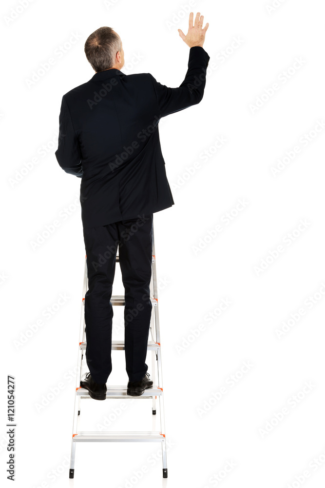 Businessman climbing a ladder Businessman climbing a ladder