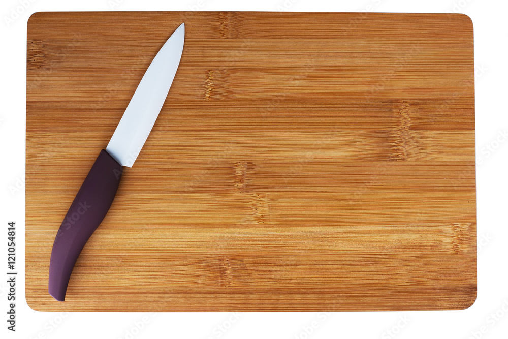 ceramic knife with a purple pen on cutting board. ceramic knife with a purple pen on cutting board.