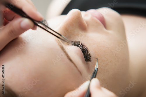 Eyelash Extension Procedure.  Woman Eye with Long Eyelashes.