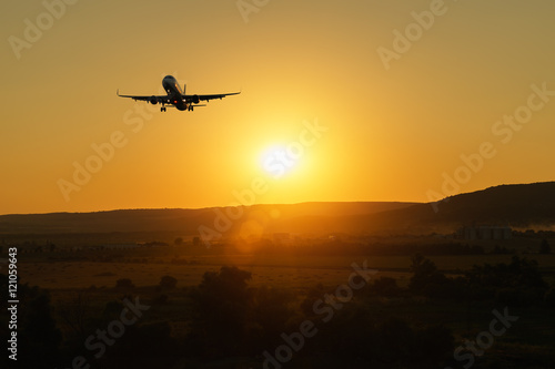 Wallpaper Mural Aircraft flying in the sky against a background of a bright sunset. Basic background for design Torontodigital.ca